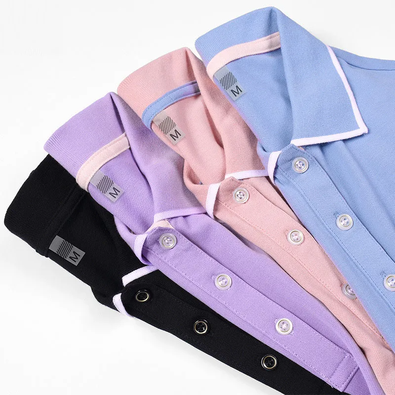 Stack of folded shirts in purple, pink, black, and blue on a white background