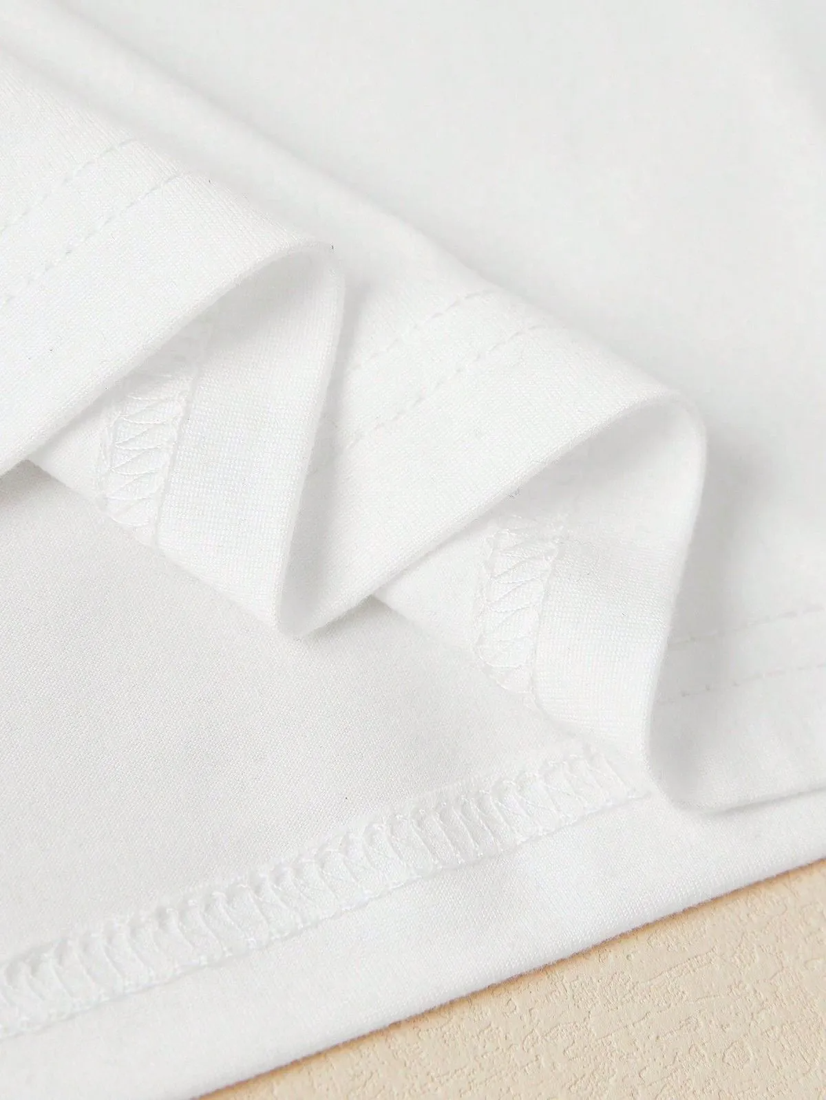 Close-up of white fabric details on a trendy crop top for women by Multypros