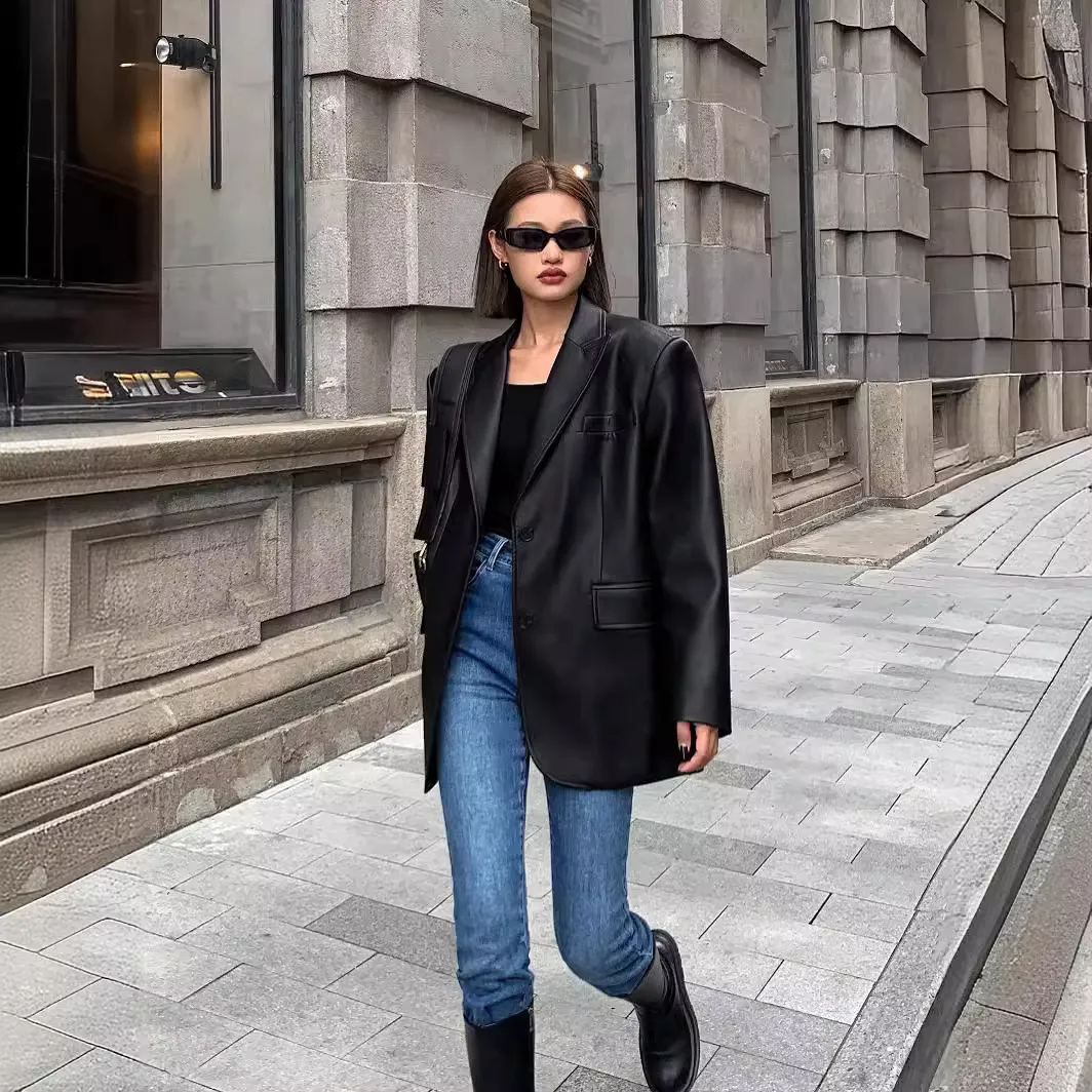 Woman wearing a black casual long sleeve lapel coat walking on a city sidewalk