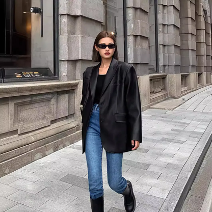 Woman wearing a black casual long sleeve lapel coat walking on a city sidewalk