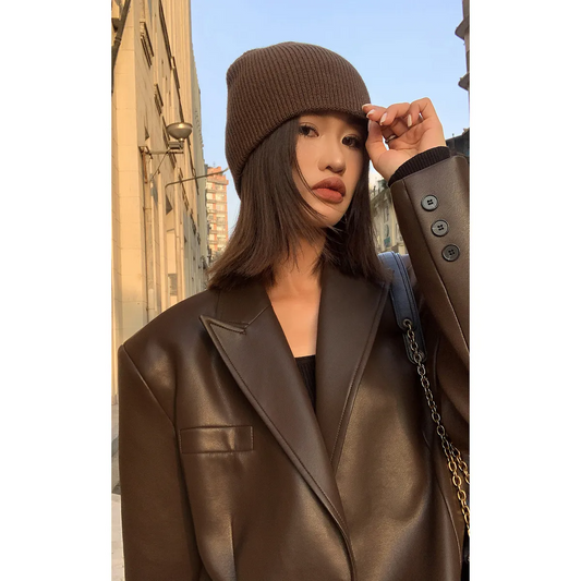 Woman wearing a brown casual long sleeve lapel coat with a matching knit hat outdoor