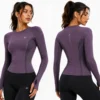 Front & Back Model View Women’s plum purple technical activewear top shown from front and back views, featuring ergonomic seam construction, breathable mesh panels, long sleeves, thumbhole cuffs, and performance-focused design