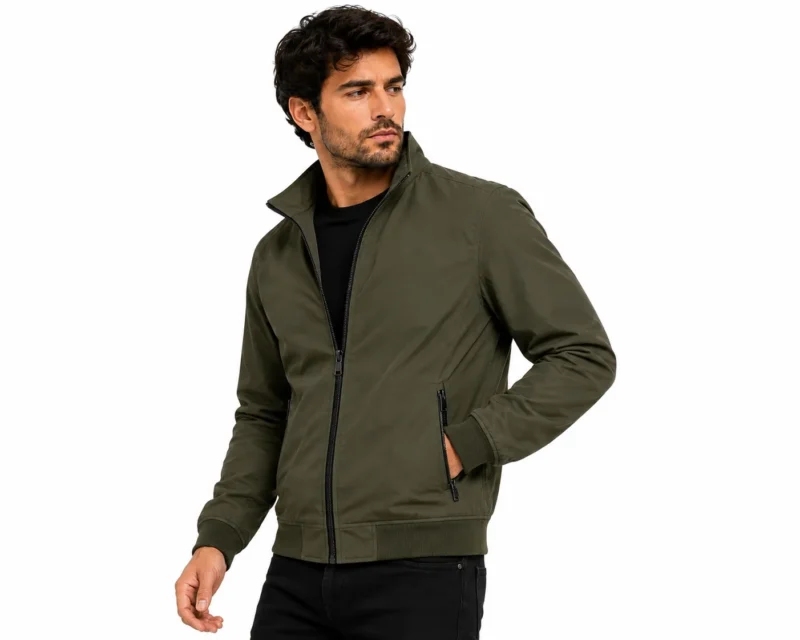 Olive Bomber Jacket Fashion Portrait Man wearing a green bomber jacket with a full front zipper, stand collar, secure zippered pockets, ribbed cuffs and waistband for a modern casual streetwear look.