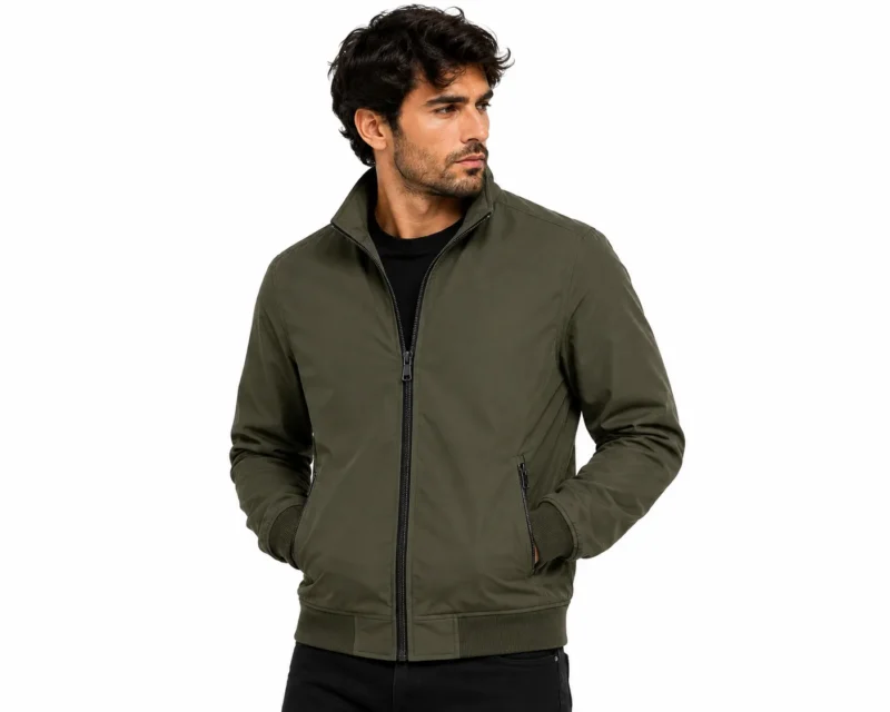 Olive Green Jacket Catalogue Portrait Men's green bomber jacket styled for streetwear, featuring a full zip closure, stand collar, ribbed waistband and cuffs, secure side pockets and minimalist detailing.