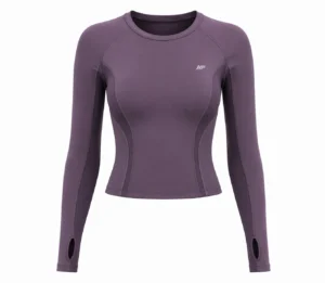 Women’s plum purple technical performance top with long sleeves, contoured body panels, breathable mesh side panels, flatlock stitching, crew neck, and thumbhole cuffs