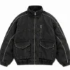 Vintage bomber jacket in washed black denim featuring a stand collar, full front zipper, large flap pockets, chest zip pocket, contrast piping, elastic cuffs and waistband.