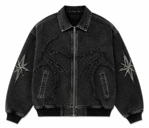 custom-jean-jacket-front Custom jean jacket in black washed denim featuring a full front zipper, pointed collar, ribbed cuffs and hem, embroidered graphic detailing and decorative sleeve patches.