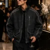 men-wearing-bomber-jacket-vintage Men's vintage bomber jacket styled for streetwear, featuring washed black denim, stand collar, full zip closure, utility pockets, contrast piping and elastic waistband.