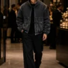 mens-vintage-bomber-jacket-streetwear Man wearing a vintage bomber jacket in washed black denim with a full zipper, large flap pockets, chest zip pocket, contrast piping and elastic cuffs for modern streetwear.