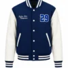 Blue varsity jacket with white leather sleeves, striped ribbed collar and cuffs, snap button closure, embroidered name and number 29 chenille patch on the chest.