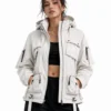 Woman wearing a white techwear jacket featuring multiple cargo pockets, high collar, hood, front zipper, adjustable straps and technical details for a futuristic streetwear look.