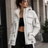 Women's white techwear jacket styled for futuristic streetwear, featuring multiple utility pockets, zip closures, adjustable straps, hood and a modern technical silhouette.