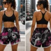 womens-custom-athletic-shorts-streetwear Women's custom athletic shorts styled for streetwear, featuring an all-over graphic print, elastic waistband, white drawstring, contrast trim and a bold contemporary design.